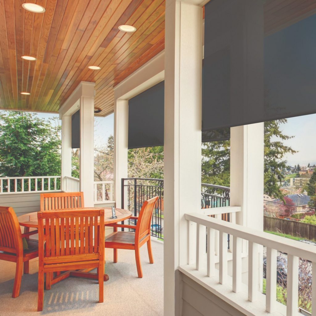 Furnished covered balcony with lights, and a view.